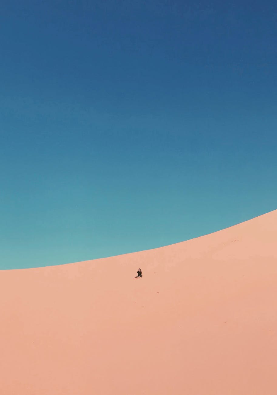 person at a desert under blue sky